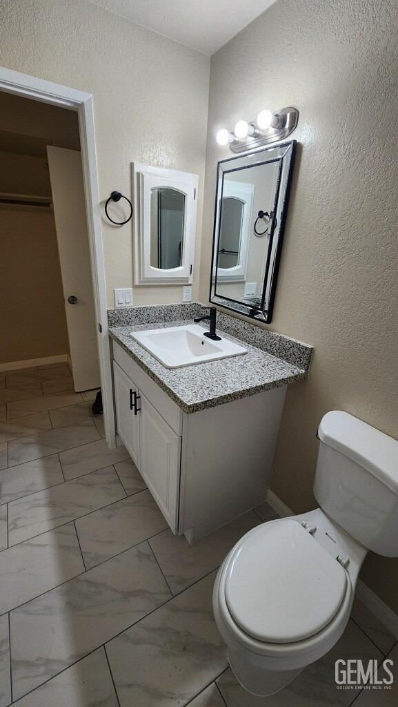 bathroom with vanity and toilet