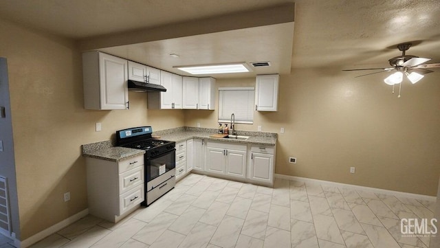 kitchen featuring light stone counters, sink, gas stove, and white cabinets