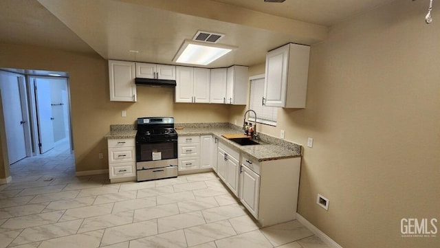 kitchen with white cabinetry, stainless steel range with gas stovetop, light stone countertops, and sink