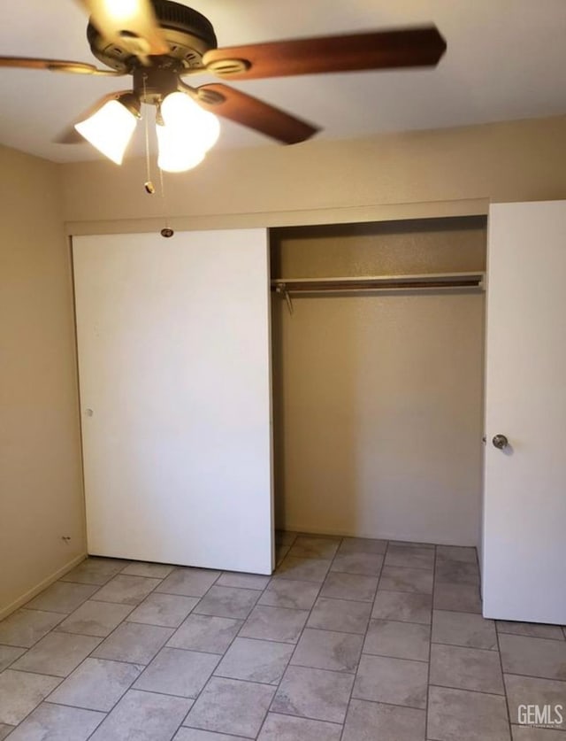 unfurnished bedroom featuring light tile patterned floors, a closet, and ceiling fan