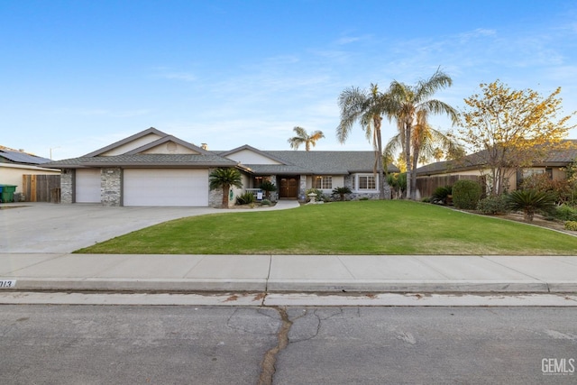 view of front facade with a garage, driveway, fence, and a front lawn