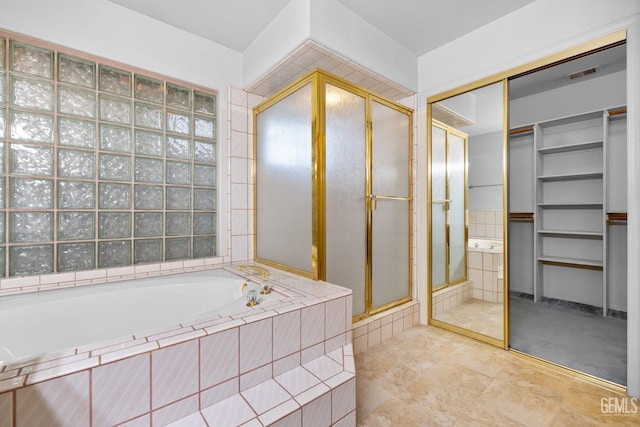 full bathroom featuring a stall shower, visible vents, a garden tub, and a spacious closet