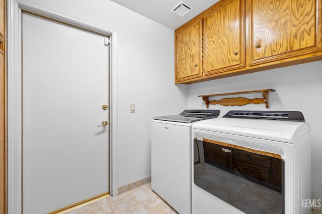 clothes washing area featuring light tile patterned floors, visible vents, cabinet space, separate washer and dryer, and baseboards