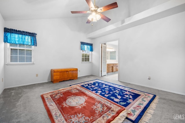 empty room with carpet, vaulted ceiling, baseboards, and ceiling fan