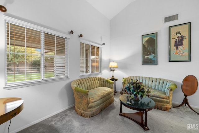 living area featuring lofted ceiling, carpet, visible vents, and baseboards