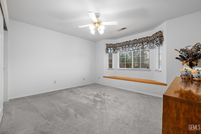 unfurnished bedroom with a ceiling fan, carpet, visible vents, and baseboards