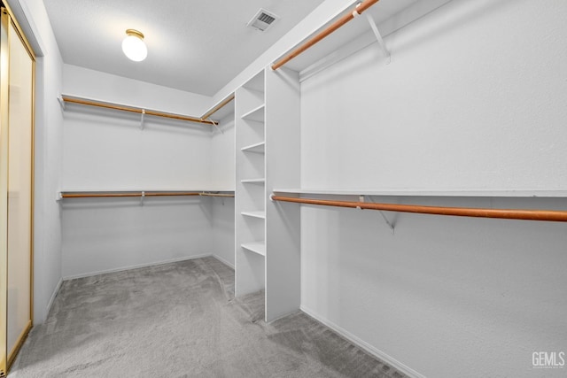 spacious closet with carpet floors and visible vents