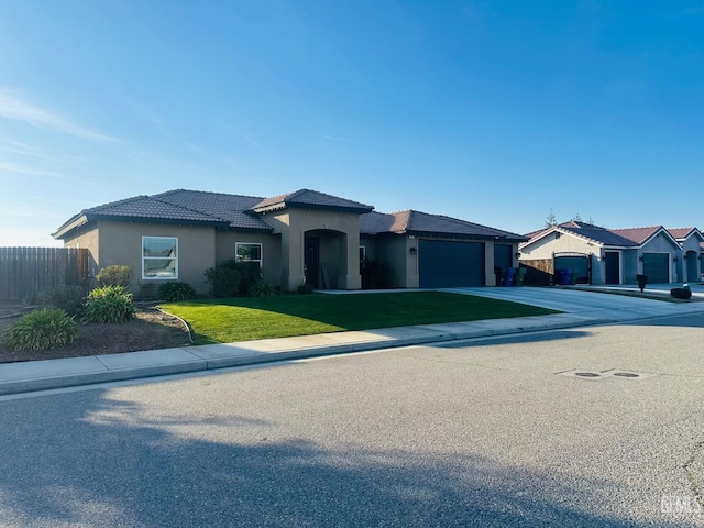 view of front of home with a garage, a tile roof, fence, concrete driveway, and a front lawn