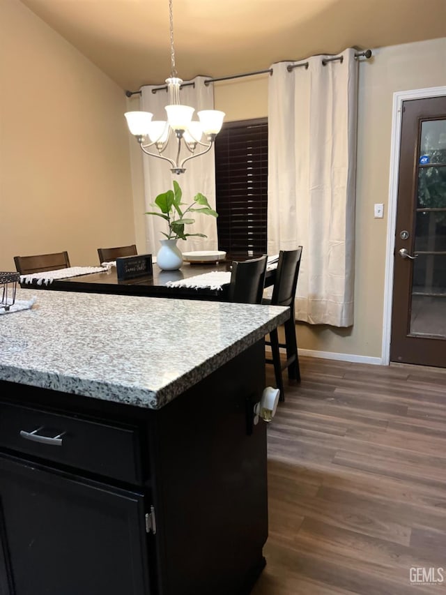 kitchen with a chandelier, pendant lighting, and dark hardwood / wood-style floors