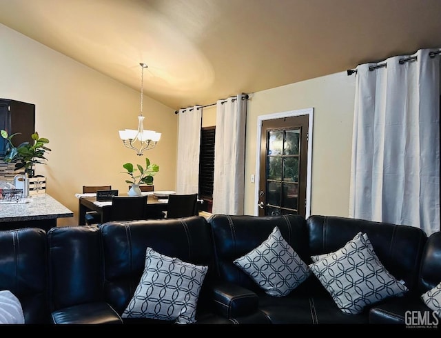 living room with vaulted ceiling and an inviting chandelier