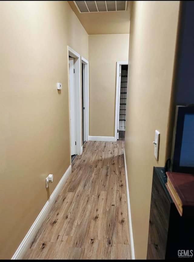 corridor with light wood-type flooring