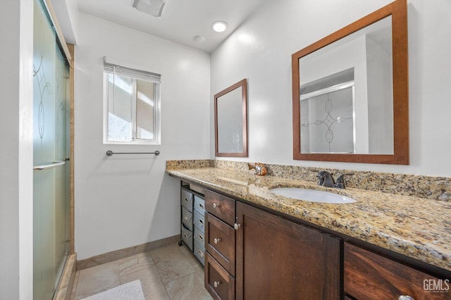 bathroom featuring walk in shower, vanity, and tile patterned flooring