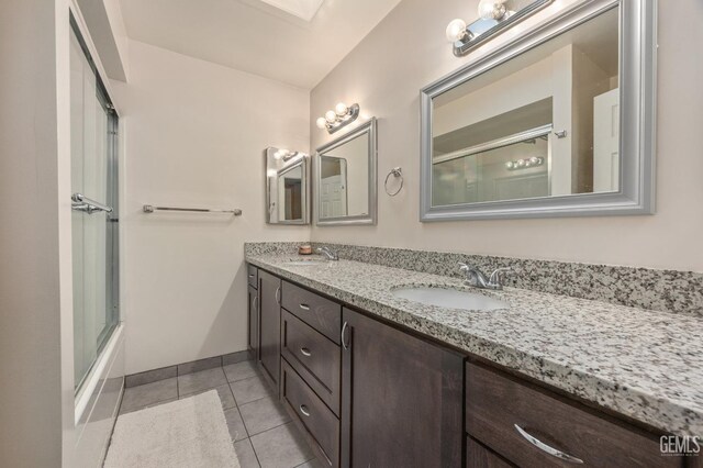 bathroom with vanity, tile patterned floors, and shower / bath combination with glass door