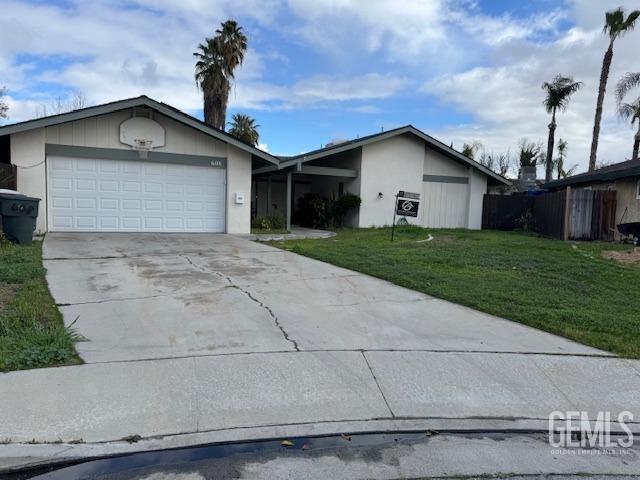 ranch-style home with a garage and a front yard