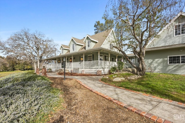 view of front facade featuring covered porch and a front yard