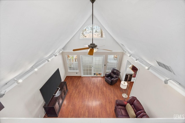 living room featuring hardwood / wood-style flooring, high vaulted ceiling, and ceiling fan