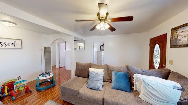 living room featuring ceiling fan and hardwood / wood-style floors