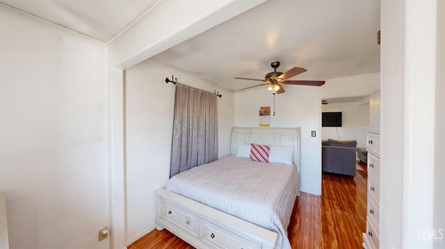 bedroom with ceiling fan and dark hardwood / wood-style flooring