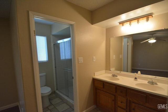 bathroom with walk in shower, tile patterned floors, toilet, vanity, and ceiling fan