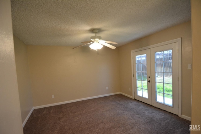 carpeted spare room with french doors, ceiling fan, and a textured ceiling