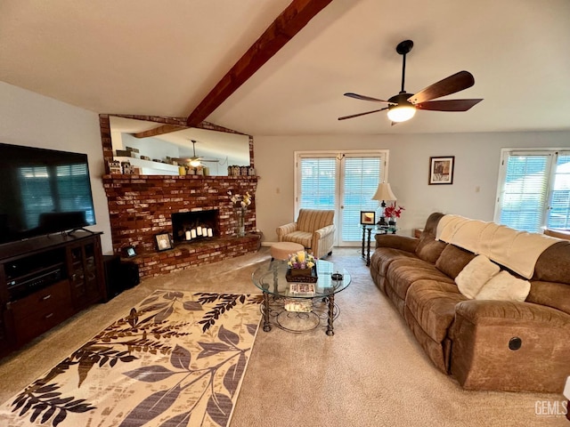 carpeted living area featuring beamed ceiling, ceiling fan, and a fireplace
