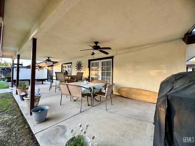 view of patio featuring a ceiling fan, area for grilling, and outdoor dining space