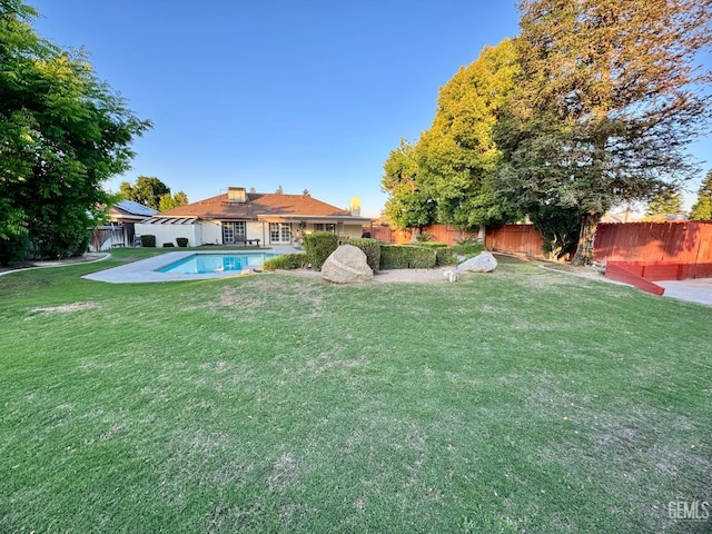 view of yard featuring a fenced in pool and a fenced backyard