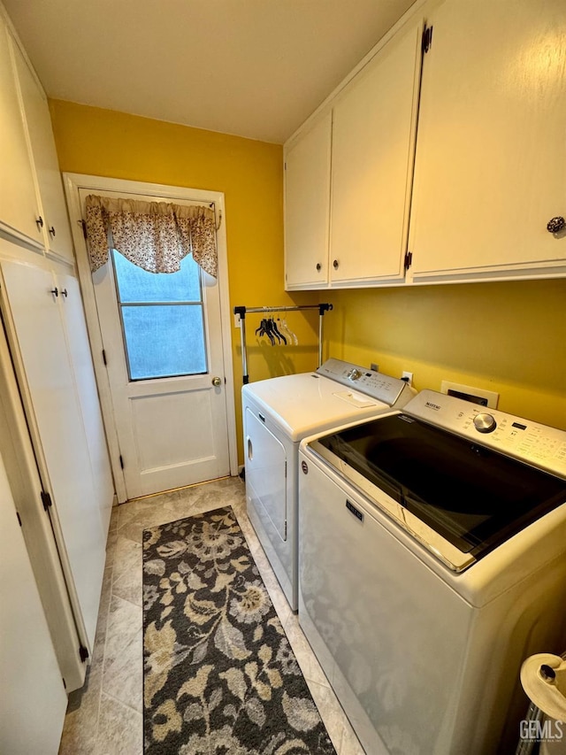 laundry room featuring washing machine and dryer and cabinet space