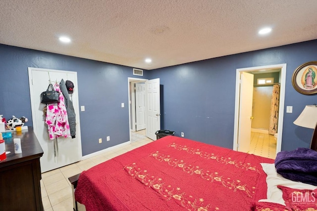 bedroom with recessed lighting, a textured ceiling, visible vents, and tile patterned floors