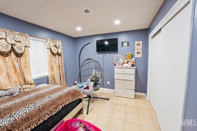 bedroom featuring recessed lighting, a textured ceiling, tile patterned floors, and baseboards