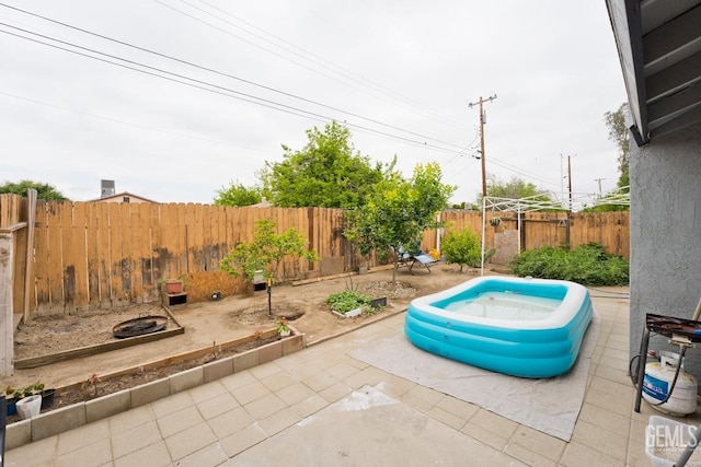view of patio / terrace featuring a swimming pool and a fenced backyard