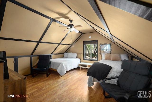 bedroom featuring lofted ceiling with skylight and light wood-type flooring