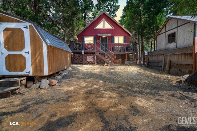 rear view of property featuring a deck