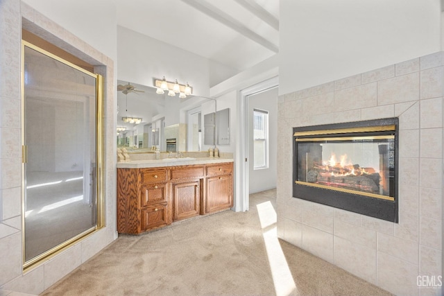 full bathroom featuring a multi sided fireplace and double vanity