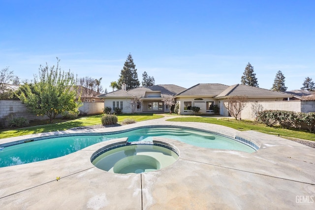 view of swimming pool with a yard, a fenced backyard, and a pool with connected hot tub