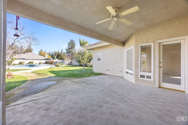 view of patio with ceiling fan and fence