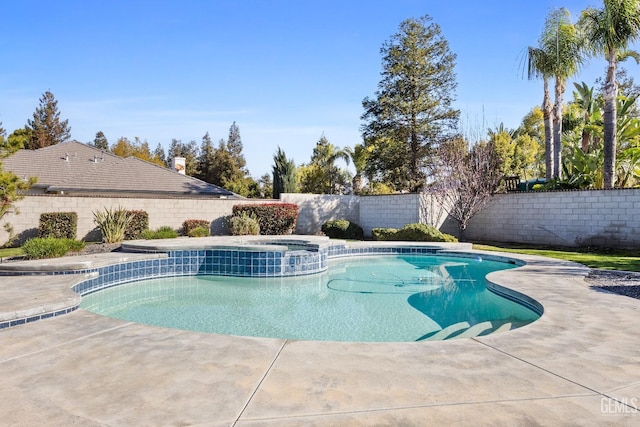 view of pool with a fenced backyard, a pool with connected hot tub, and a patio