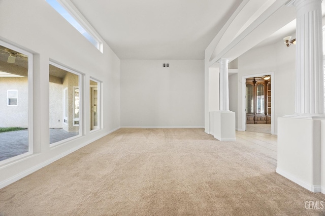 spare room with light carpet, decorative columns, visible vents, and baseboards