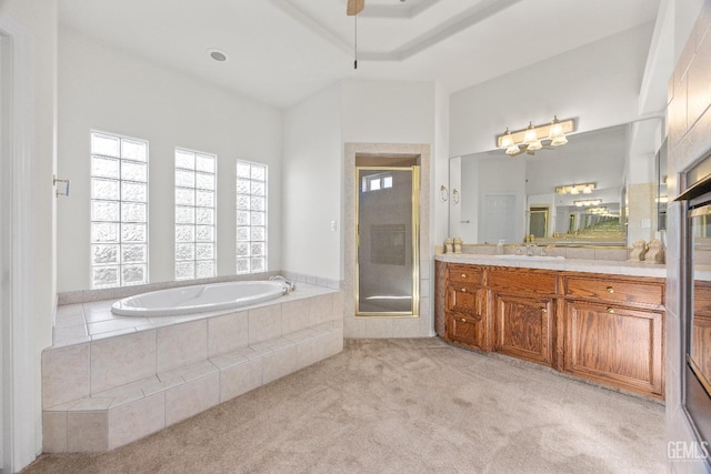 full bathroom featuring a ceiling fan, carpet flooring, vanity, a shower stall, and a bath