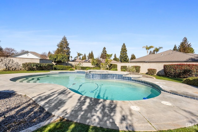 view of swimming pool with a patio area, a fenced backyard, and a pool with connected hot tub