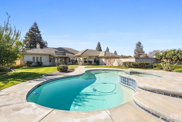 view of pool with a fenced in pool, a yard, fence, and an in ground hot tub