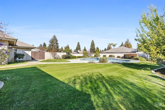 view of yard featuring a fenced in pool and a fenced backyard