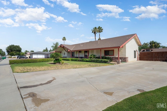 11906 Christy Ave, Bakersfield, CA 93312 - ranch-style home with concrete driveway, a front yard, stone siding, and stucco siding