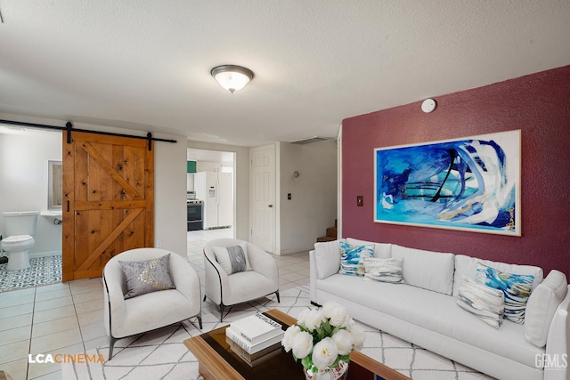 11906 Christy Ave, Bakersfield, CA 93312 - living room with a barn door, a textured ceiling, and light tile patterned floors