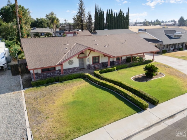 11906 Christy Ave, Bakersfield, CA 93312 - view of front facade featuring a front lawn, concrete driveway, a residential view, stucco siding, and roof with shingles