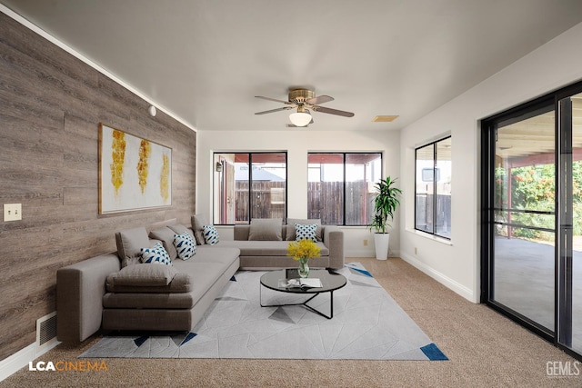 11906 Christy Ave, Bakersfield, CA 93312 - carpeted living area with wooden walls, a ceiling fan, and an accent wall