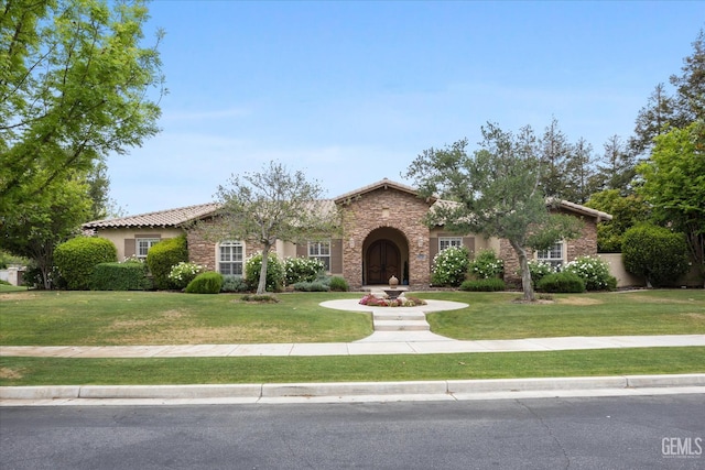 11416 Queensbury Dr, Bakersfield, CA 93312 - view of front of home with stone siding, a front lawn, stucco siding, and a tile roof