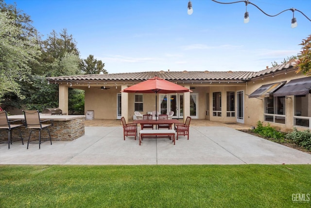 11416 Queensbury Dr, Bakersfield, CA 93312 - back of property with stucco siding, a patio area, and a lawn