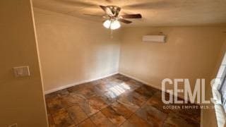 empty room featuring a wall mounted air conditioner and ceiling fan