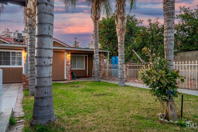 view of yard at dusk